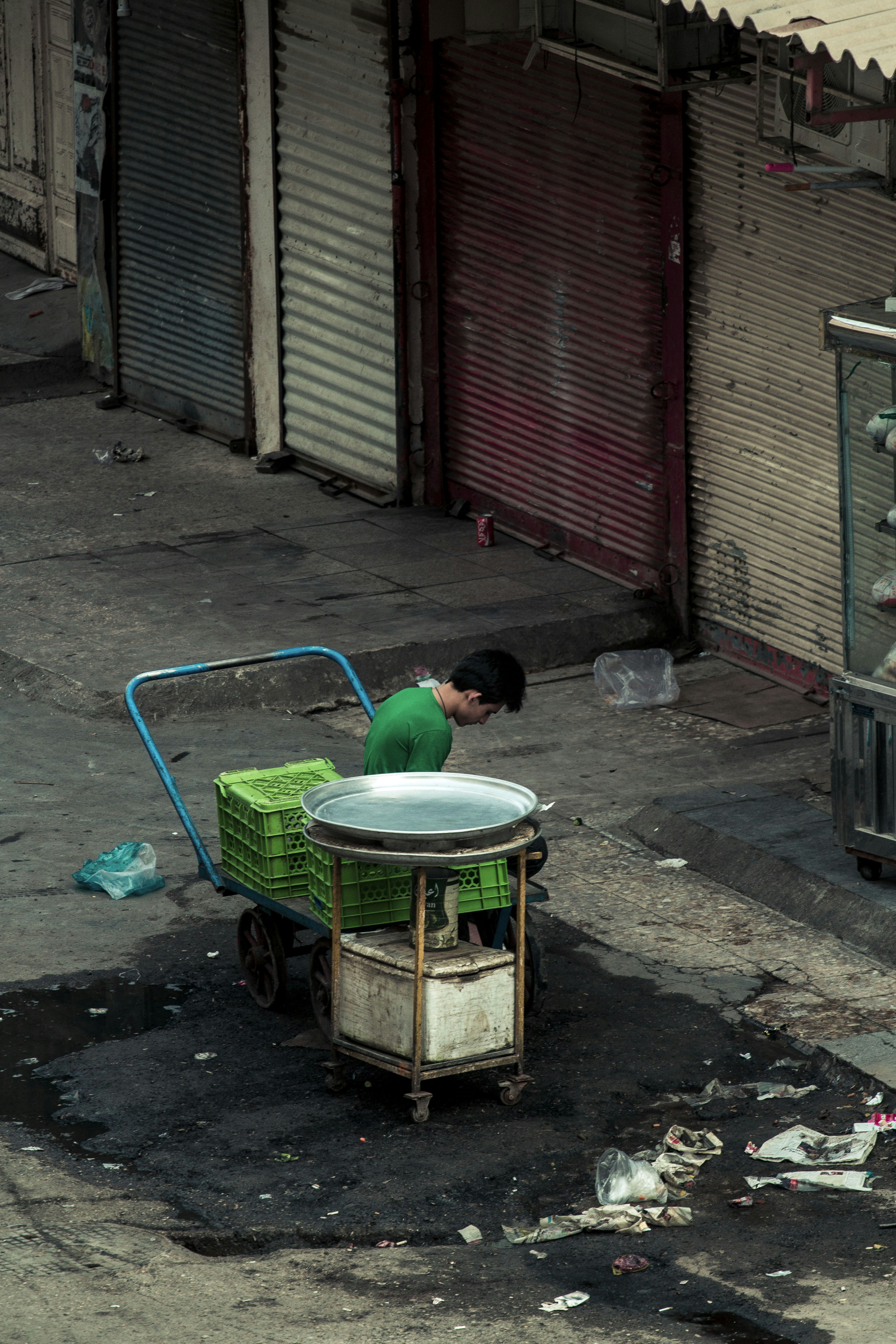 boy in green shirt sitting on green plastic basin