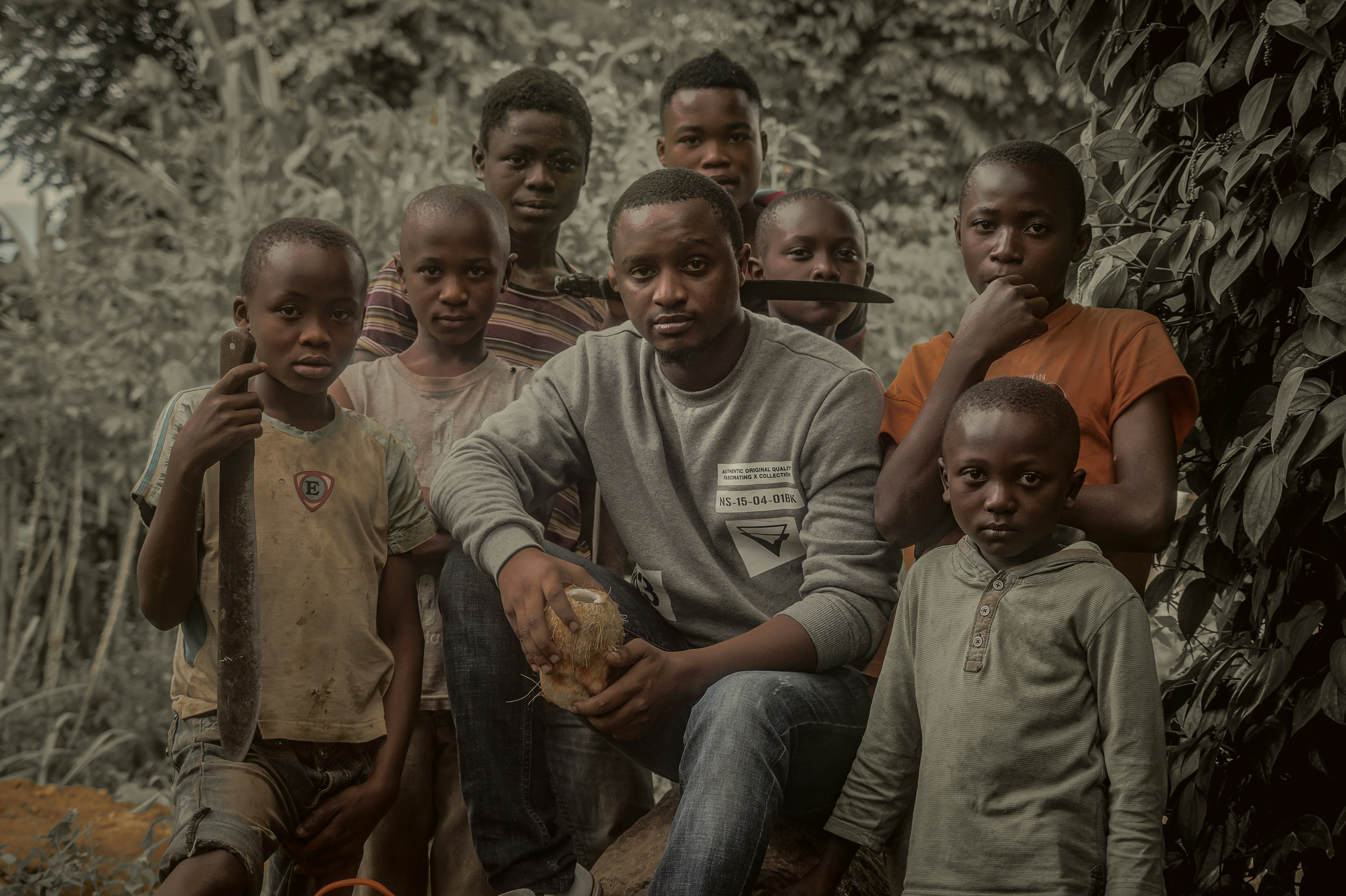 group of children sitting on gray concrete floor tanzania teams background