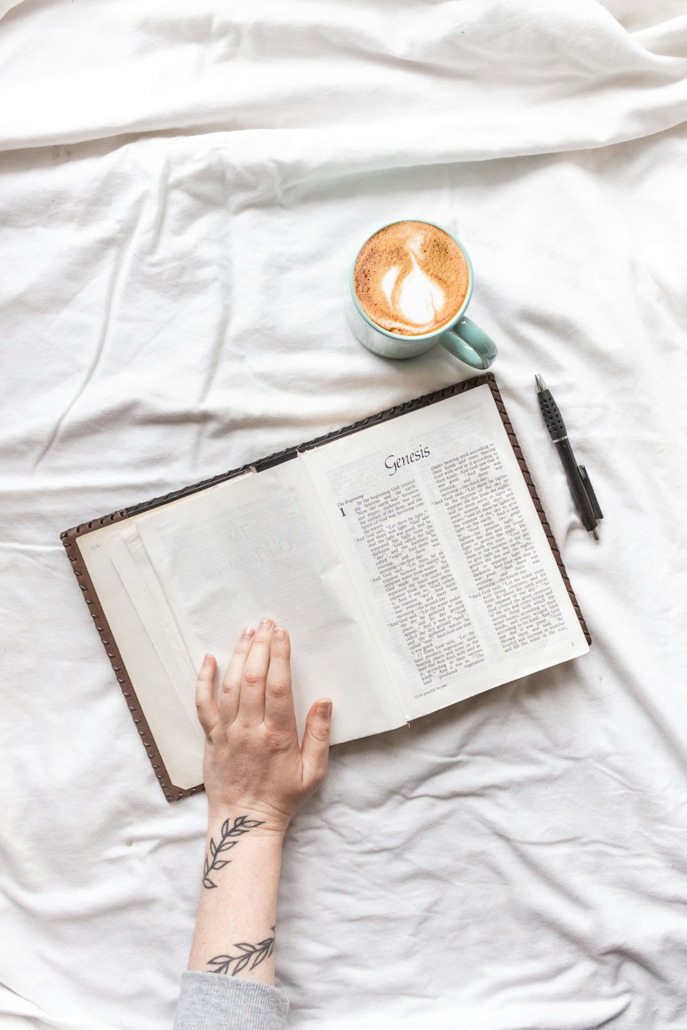 person reading book on bed