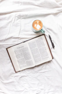 A digital tablet displaying a downloadable devotional guide with a cup of coffee nearby