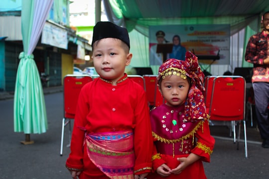 2 children in red long sleeve shirt in Jambi Indonesia