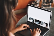 woman using macbook pro on table