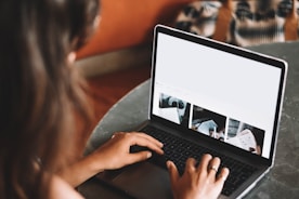 woman using macbook pro on table