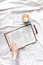 A friendly author mentoring a client over coffee, discussing manuscript details.