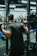 Woman doing a squat exercise in a bright, elegant home gym setting.
