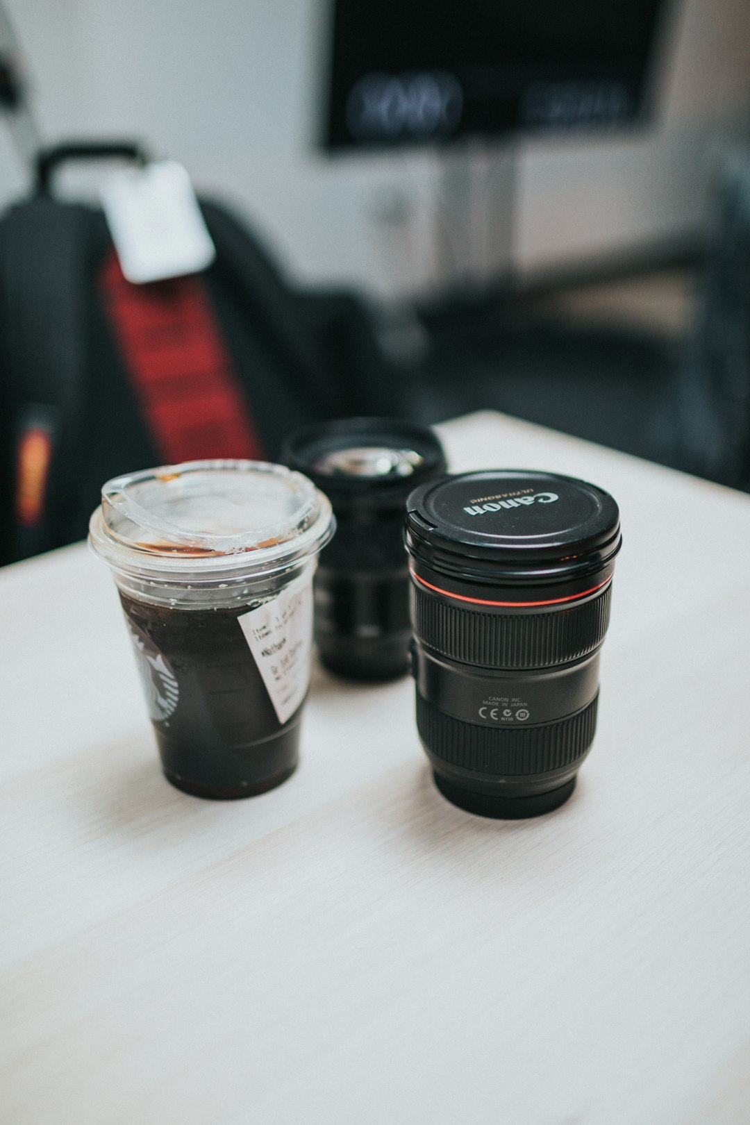 black camera lens on white table