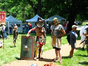 A detailed Roman military camp bustling with legionnaires training and preparing equipment.