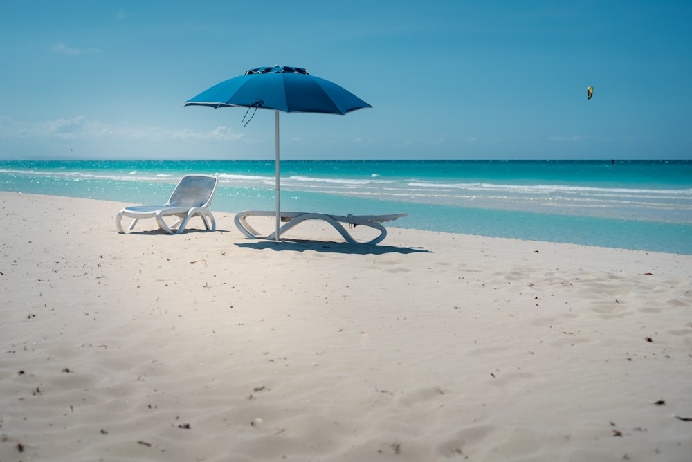 blue umbrella on beach during daytime