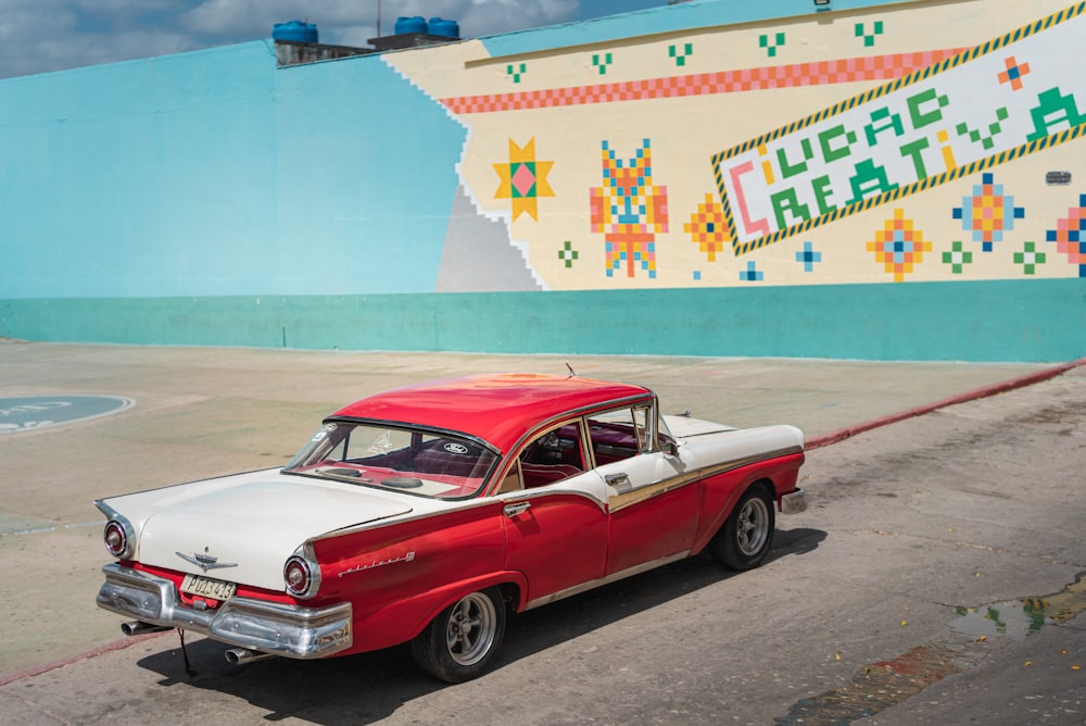 red and white vintage car on road