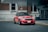 red bmw m 3 parked on sidewalk during daytime