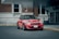 red bmw m 3 parked on sidewalk during daytime