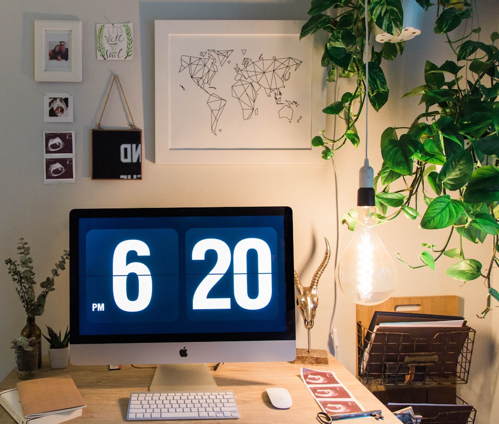 silver imac on brown wooden table