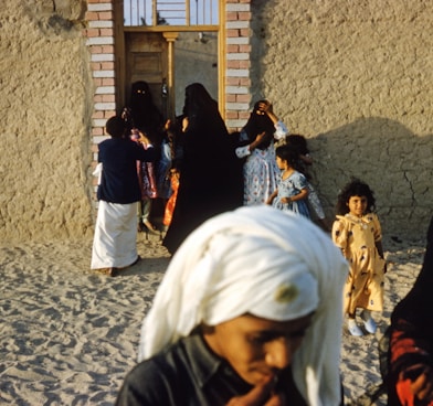 people standing near brown wooden door