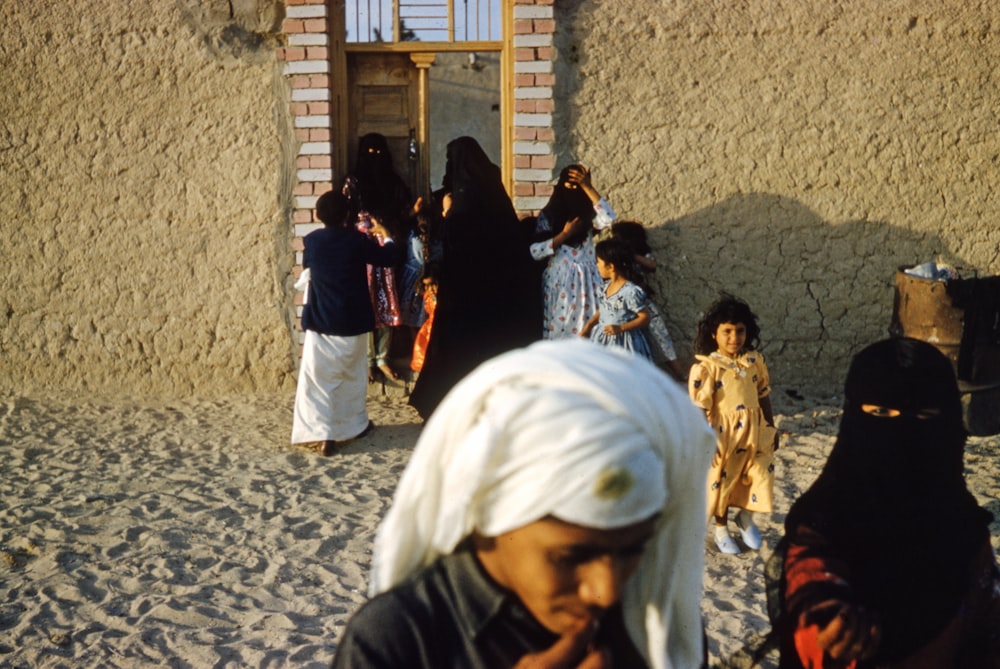 people standing near brown wooden door