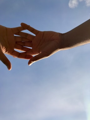 A friendly volunteer helping a person in need, with a blue sky background symbolizing hope.