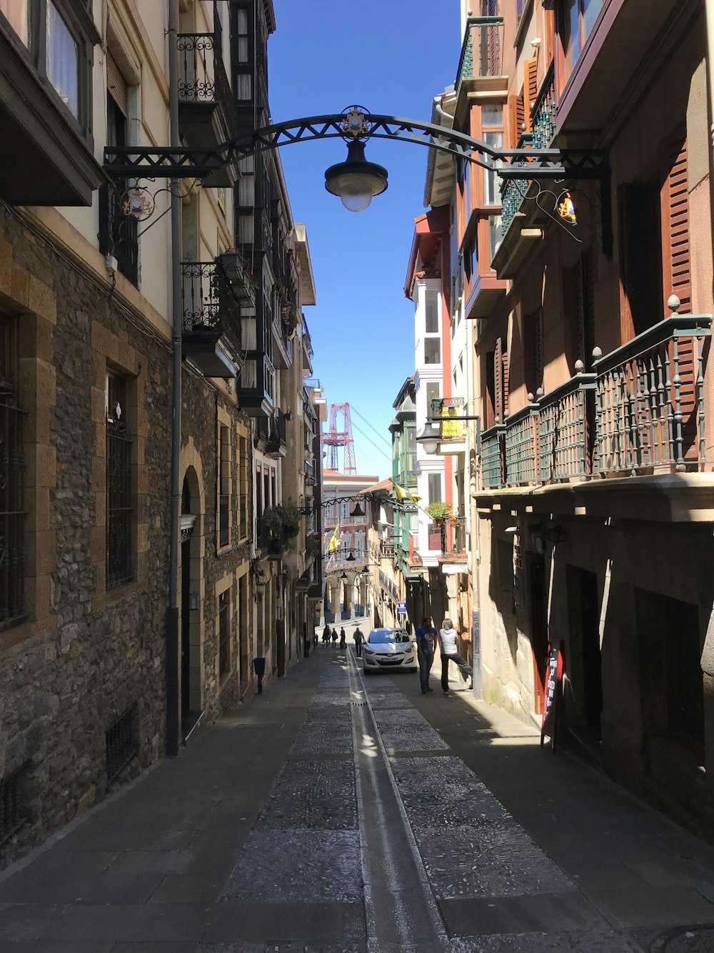 empty street in between of buildings during daytime