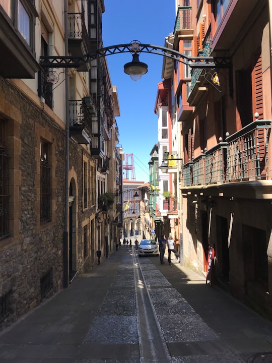 empty street in between of buildings during daytime in Portugalete Spain