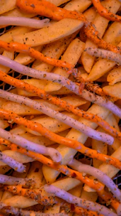 Close-up of crispy fries with a side of dipping sauce