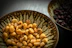 Close-up of a variety of premium dry nuts in rustic bowls on a wooden table.