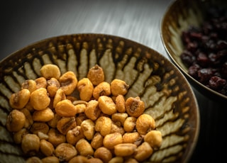 brown peanuts on black ceramic bowl