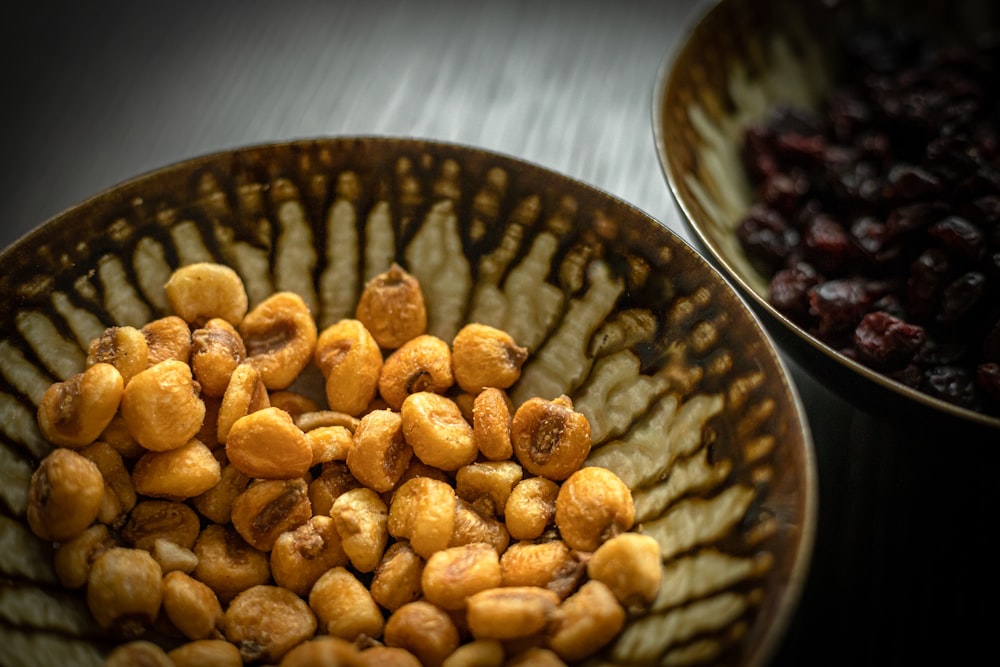 brown peanuts on black ceramic bowl