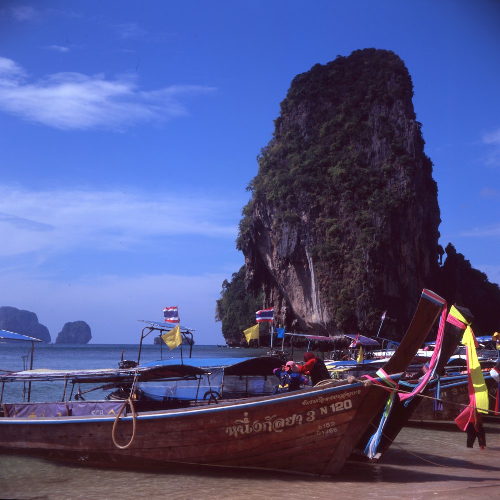 red and white boat on sea shore during daytime