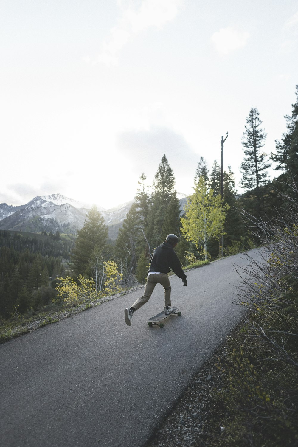 man in black t-shirt riding on bicycle on road during daytime