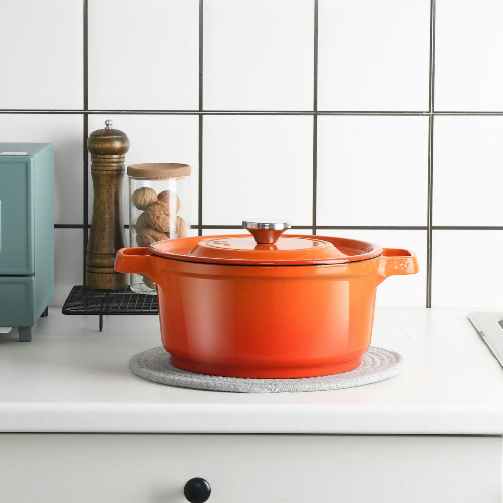 orange plastic container on white table