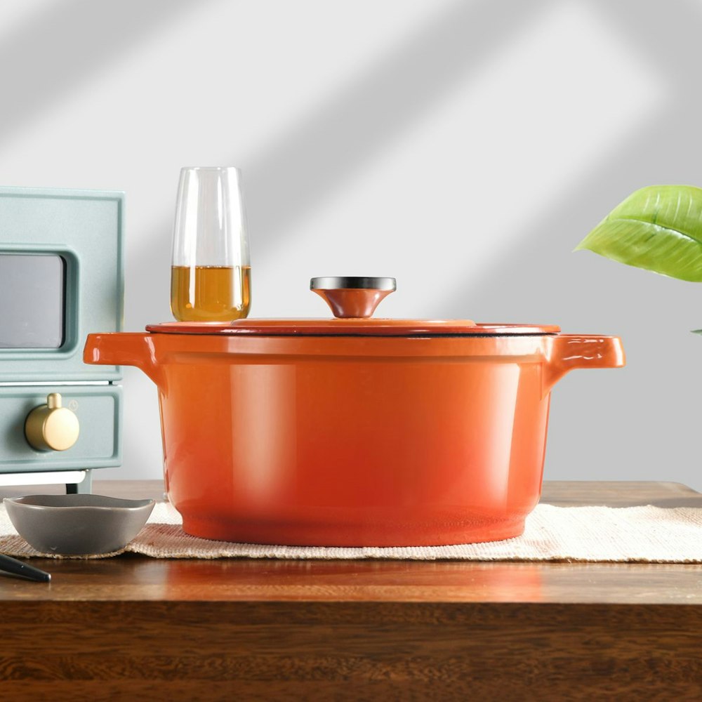 red cooking pot on white ceramic plate