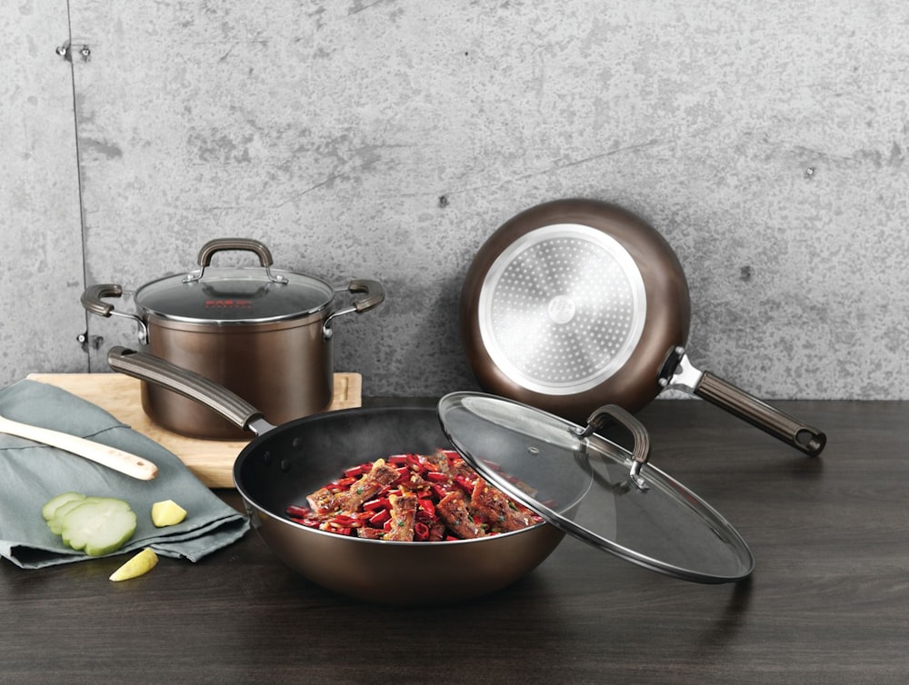 stainless steel cooking pot on brown wooden table