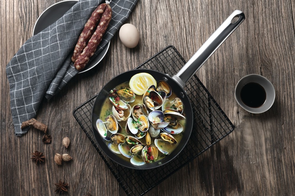 black cast iron pan with cooked food on brown wooden table