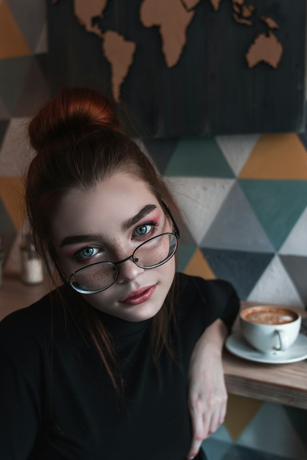 woman in black framed eyeglasses and black shirt