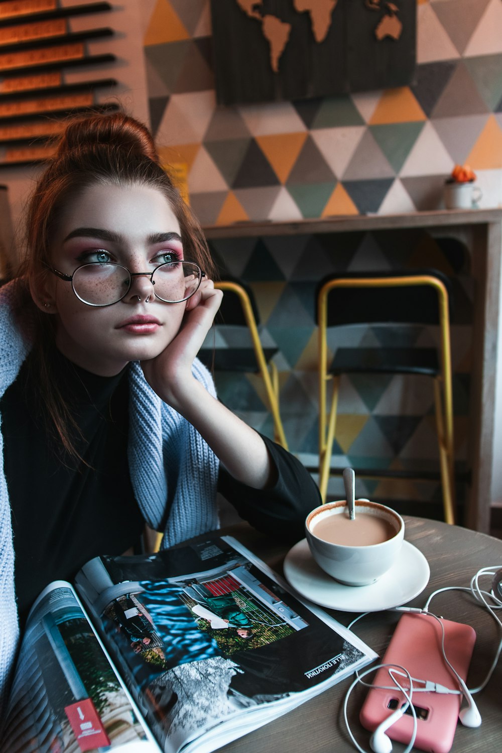 woman in black framed eyeglasses and gray cardigan