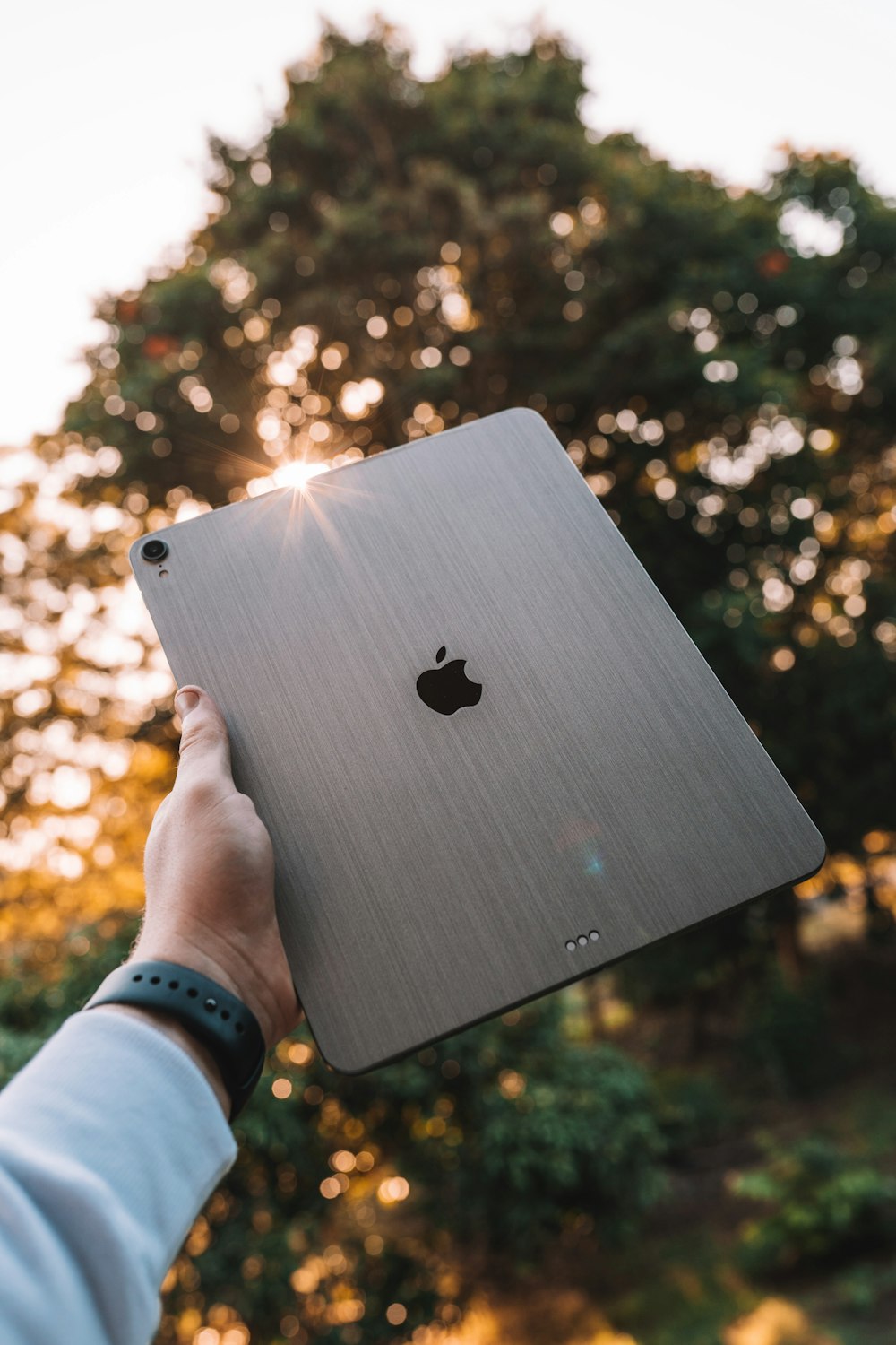 person holding silver apple macbook