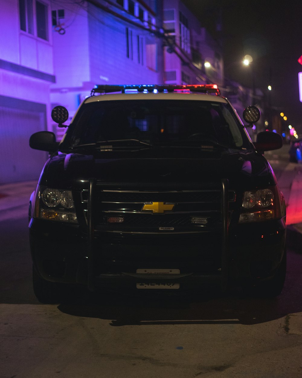 black car on road during night time