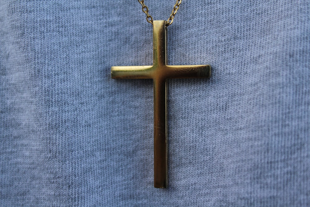 Goldenes Kreuz Anhänger Halskette auf blauem Textil