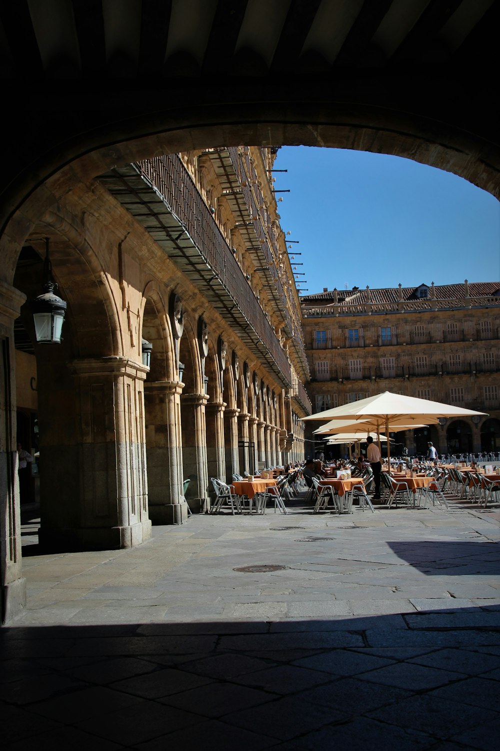 people sitting on bench near brown concrete building during daytime