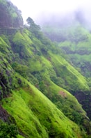 green grass covered mountain during daytime