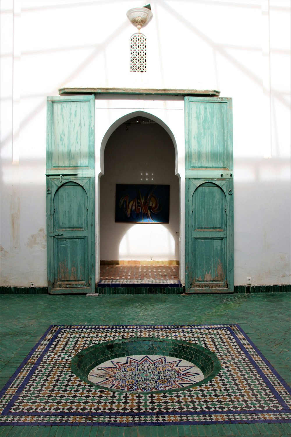 green wooden door with white light