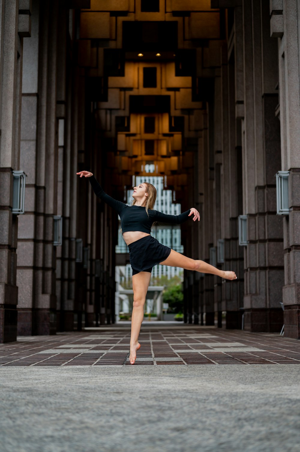 woman in black tank top and black shorts jumping on gray concrete stairs