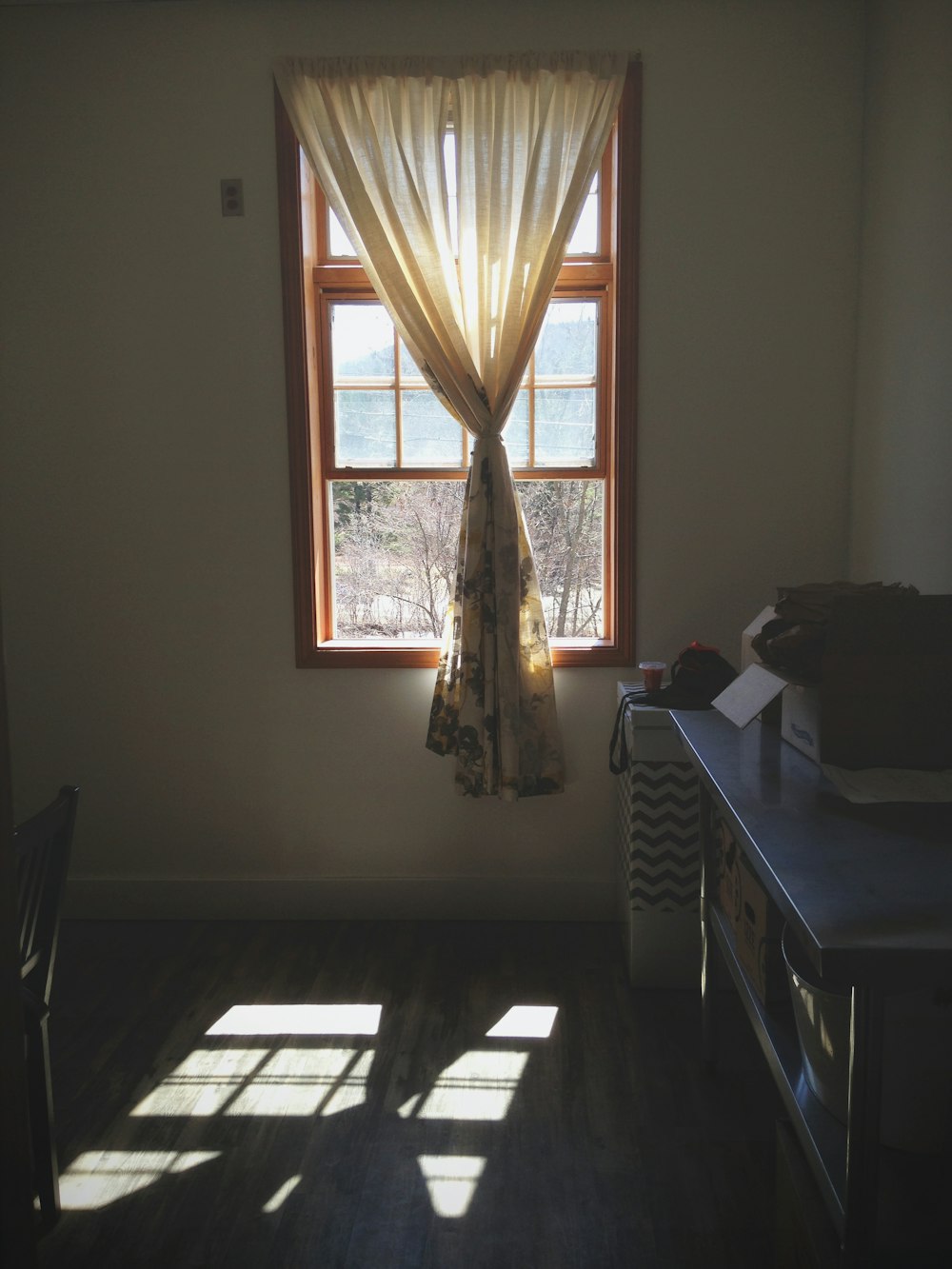 white wooden table near window