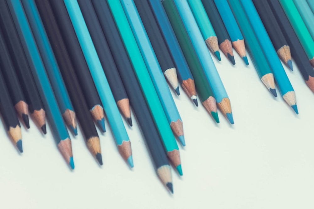 blue coloring pencils on white surface