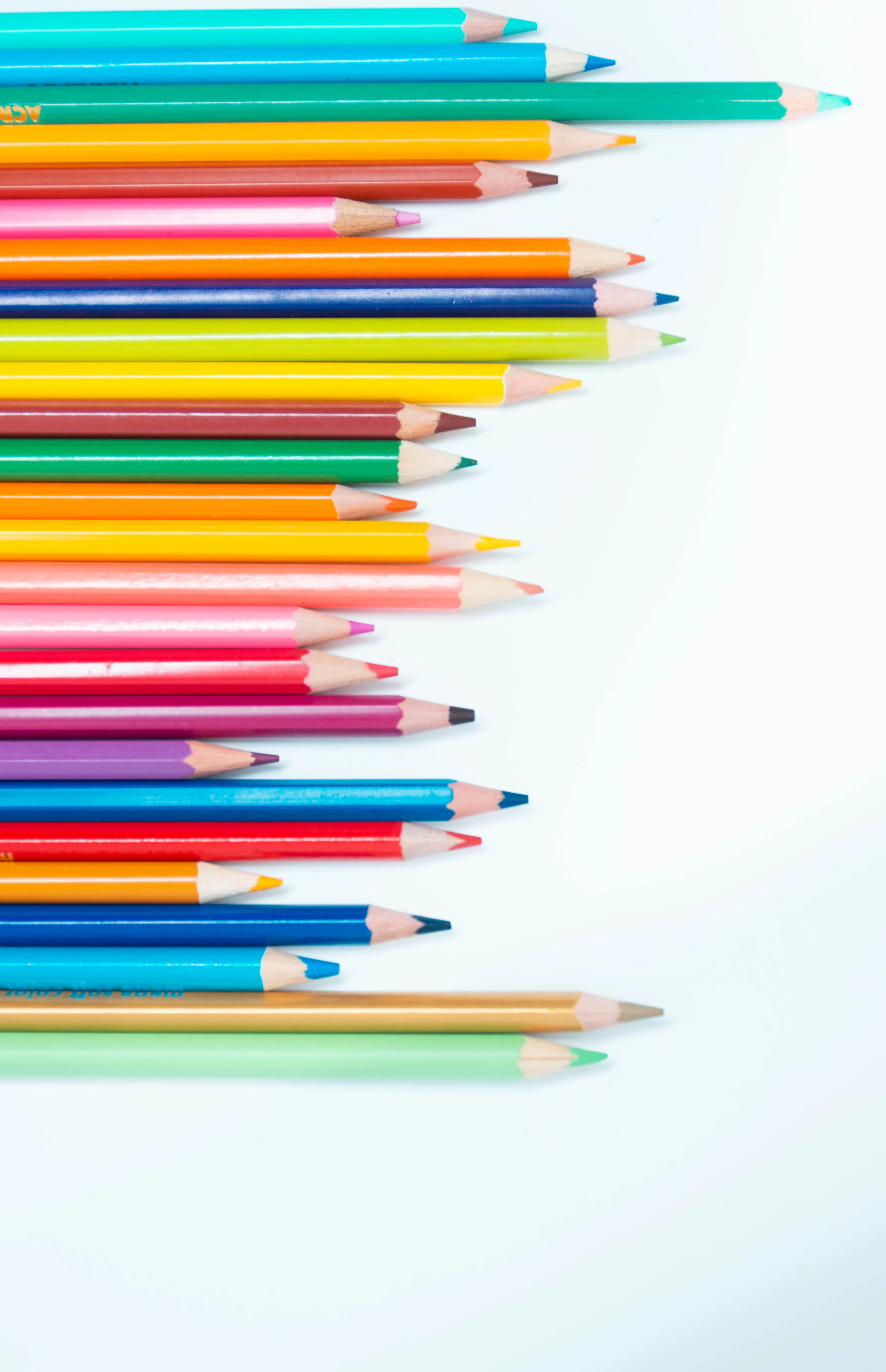 multi color coloring pencils on white surface