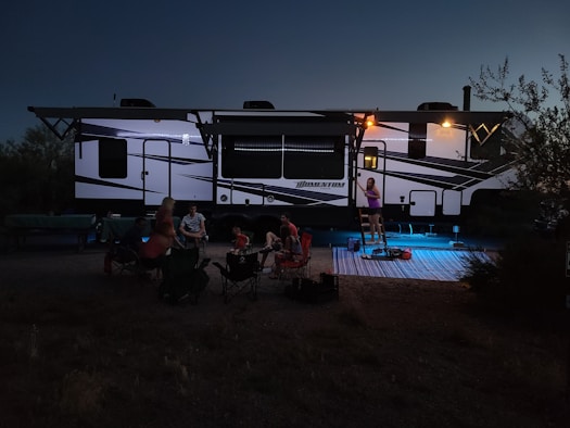 An RV running ac off of.a solar generator while people are playing