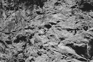 High-resolution capture of quartzite’s rugged surface contrasted against minimalistic black base