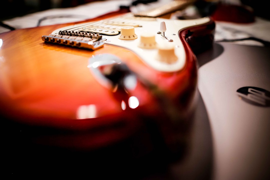 brown and white electric guitar