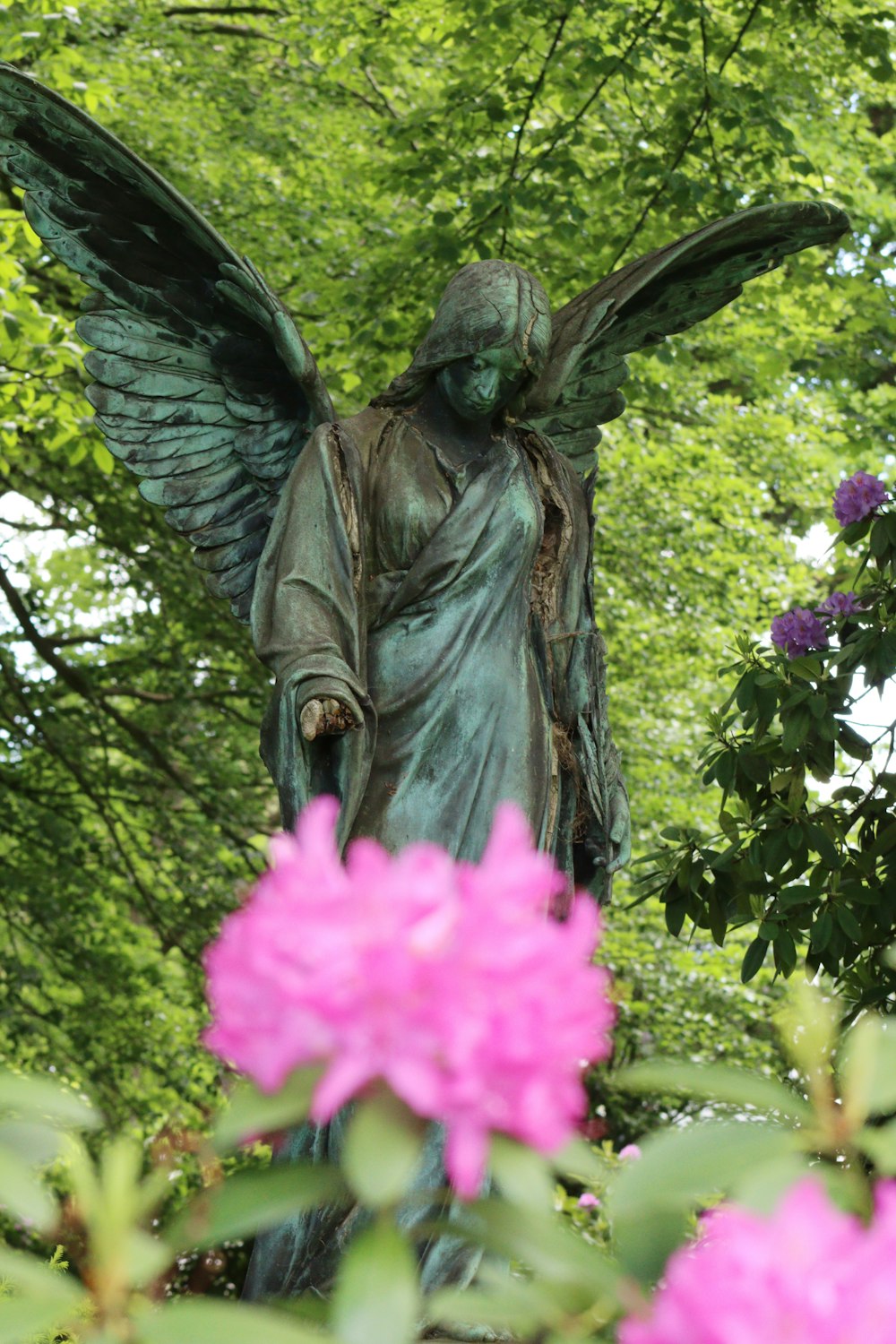 statue of a man holding a book