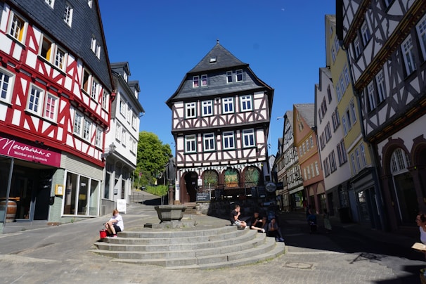 A charming medieval town square filled with colorful buildings and cobblestone streets.