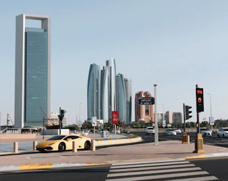 yellow car on road near building during daytime
