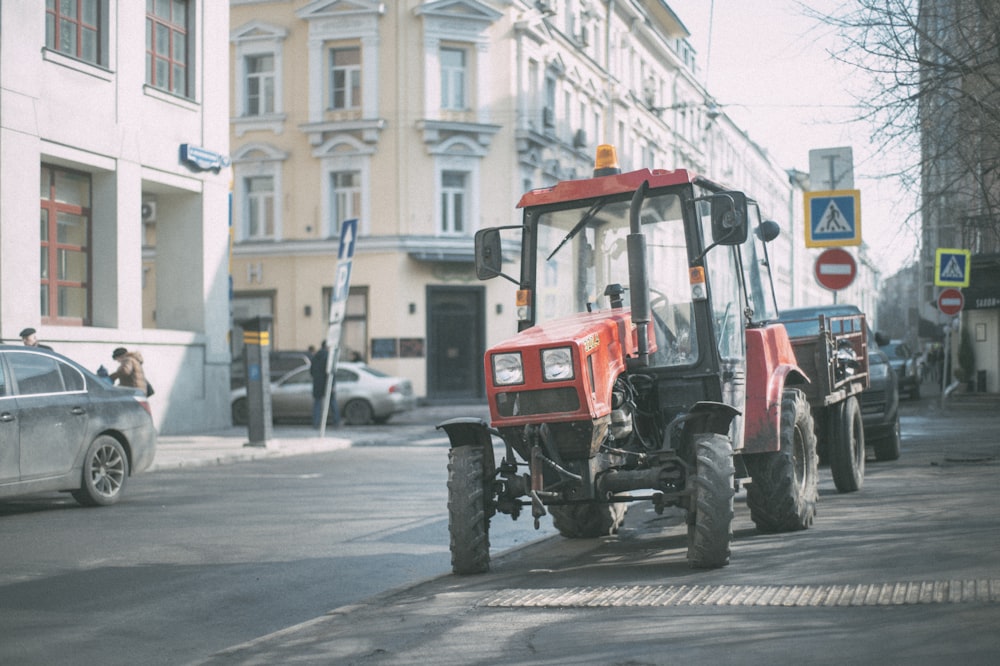 red and black tractor on road during daytime
